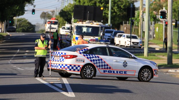 Emergency workers at the scene of a fatal motorcycle crash on Nudgee Road at Hendra on Tuesday morning.