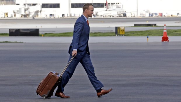 Peyton Manning wore a conservative suit in team colours.