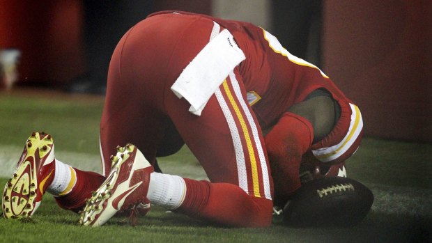 Husain Abdullah prays after intercepting a pass and running it back for a touchdown.