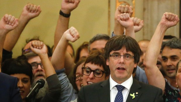 Carles Puigdemont sings the Catalan anthem inside the parliament after a vote on independence in Barcelona on Friday.