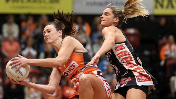 Back in orange: Bec Bulley of the Giants wins the ball under pressure from Shae Brown of the Magpies during the Super Netball major semi in early June.