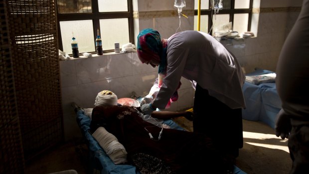 Injured in a house collapse after an airstrike in April, a woman is treated at an Iraqi Special Operations Forces field hospital in Mosul.
