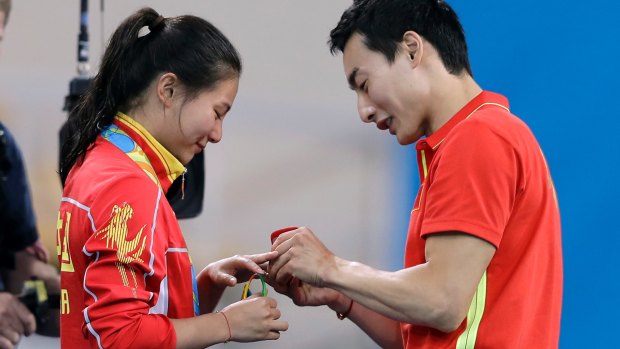 Qin Ki, right, proposed to He Zi after her medal presentation.