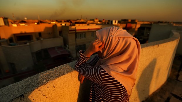 A woman, pictured in Baghdad, who lived in Fallujah when IS took it over. 