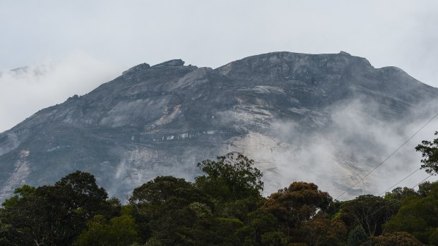 Malaysia's Mount Kinabalu is seen among mists from the Timpohon gate check point a day after the earthquake in Kundasang, Malaysia.