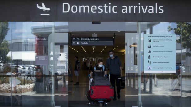 Passengers arrive at Perth Airport earlier this year. The Western Australian government has reinstated a hard border closure with Queensland as a result of the latest outbreak. 