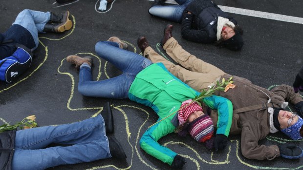Demonstrators lie on the ground in a mock death protest on Monday of the August shooting death of Michael Brown by a Ferguson police officer near St Louis, Missouri. 