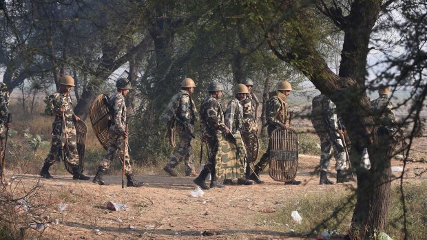 Indian police arrive near the ashram in Hisar, 175 kilometres  north of Delhi, for a showdown with the guru's armed supporters.
