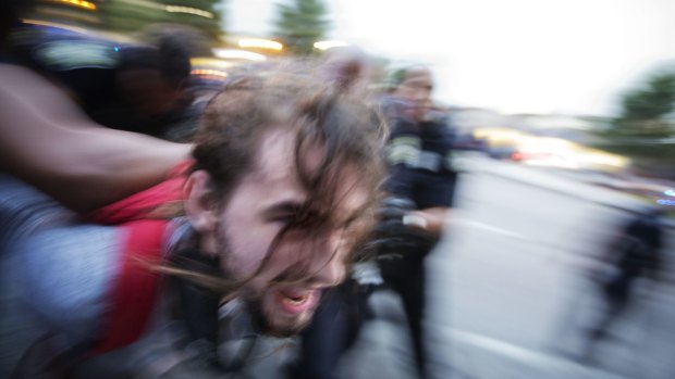A protester is arrested during a march in Atlanta on Monday. 