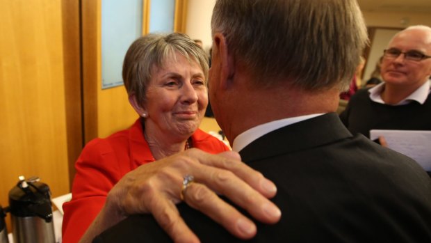 Tony Windsor is hugged by his wife Lyn after announcing his decision not to contest the 2013 election.