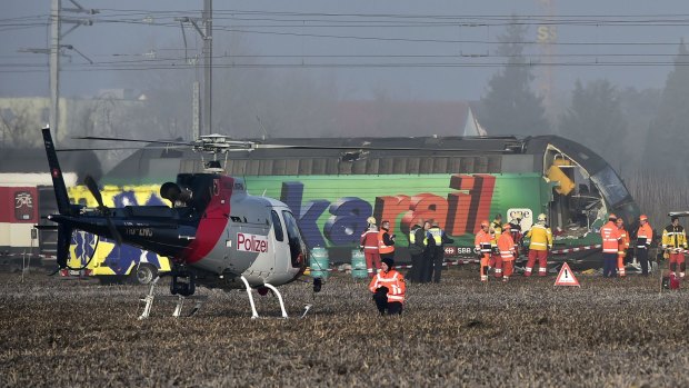 Rescue workers inspect the site of a train crash.