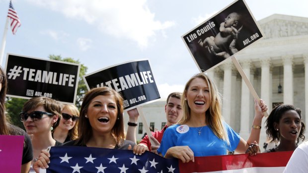 Anti-abortion protesters celebrate the US Supreme Court's ruling striking down a Massachusetts law that mandated a protective buffer zone around abortion clinics in 2014.