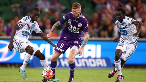 On the ball: Perth's Andy Keogh in control against Jason Geria and Thomas Deng.