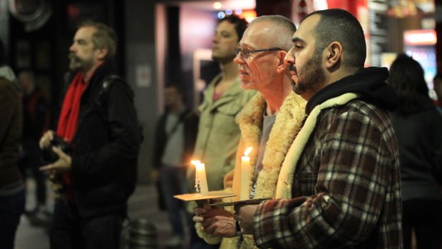 Members of the community hold a vigil in Taylor Square to pay tribute to the victims of the Orlando massacre.