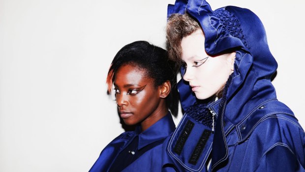 Models backstage at the Kenzo show at this year's Paris Fashion Week. The French label has announced a collaboration with Swedish fast-fashion chain H&M. 