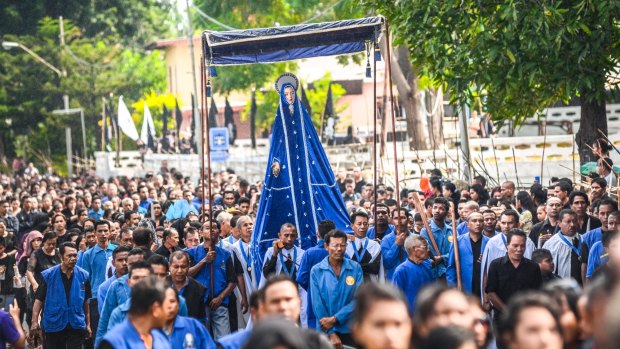 Tuan Ma (Mother Mary) statue paraded along the road during Semana Santa procession in Larantuka, Indonesia. 