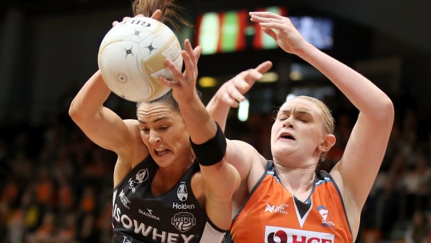 The Magpies' Sharni Layton wins the ball over Kristina Brice of the Giants.