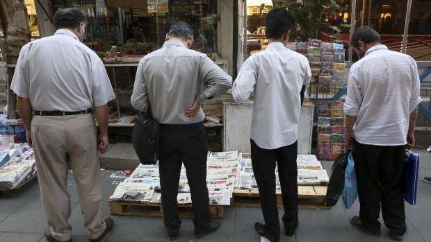 Iranian men at a newsstand in Tehran on Sunday. 