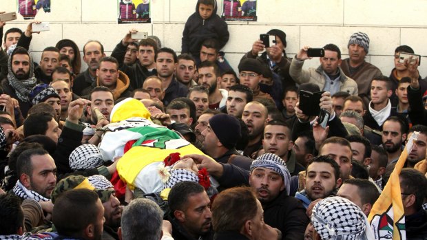 Palestinians carry the body of Ali Taqatqah, 19, at his funeral in the village of Beit Fajjar, near the West Bank city of Bethlehem last Sunday. Taqatqah and another Palestinian stabbed an Israeli soldier before Israeli troops killed them at a junction in the northern West Bank, the Israeli army said. 
