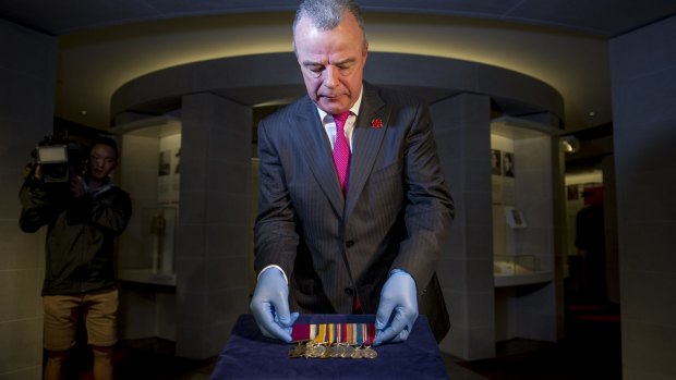 Australian War Memorial director Brendon Nelson unveils Private William Jackson's Victoria Cross medal.
