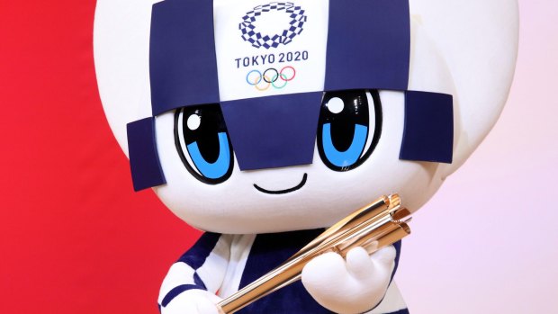 Tokyo 2020 Olympics mascot Miraitowa with the Olympic torch.