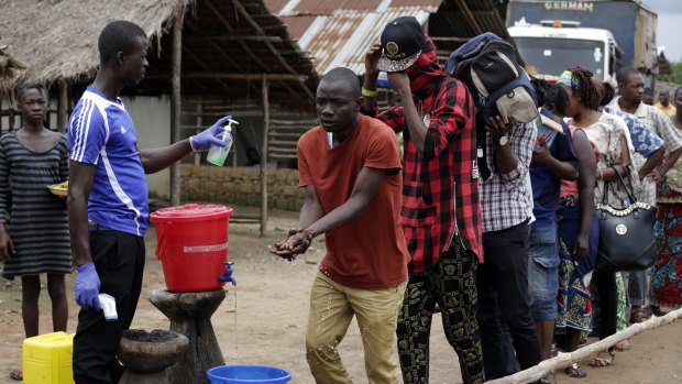 An Ebola temperature check and washing station on the edge of a quarantined area in Sierra Leone in 2015.