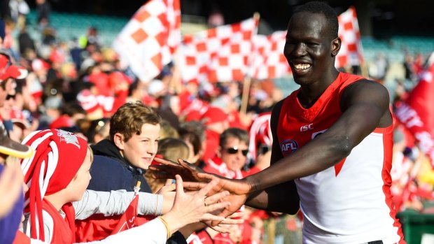 Firm favourite: Young Swans star Aliir Aliir celebrates with fans at Domain Stadium after beating the Dockers.