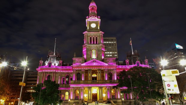 Sydney Town Hall is lit up in pink.