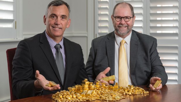 Resolute Mining boss John Welborn with the Perth Mint's Richard Hayes and part of the miner's 2015-16 dividend payment in gold bullion.