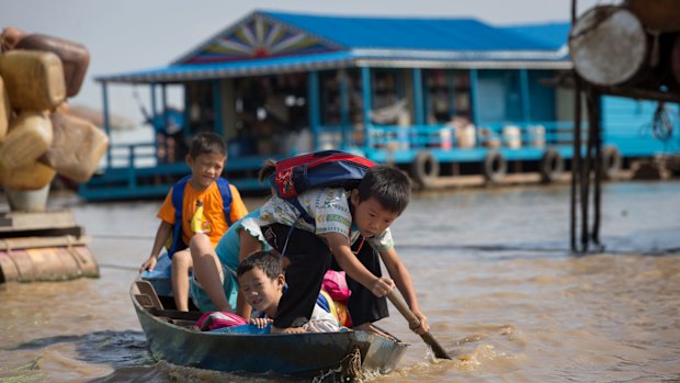 Children paddle to school.