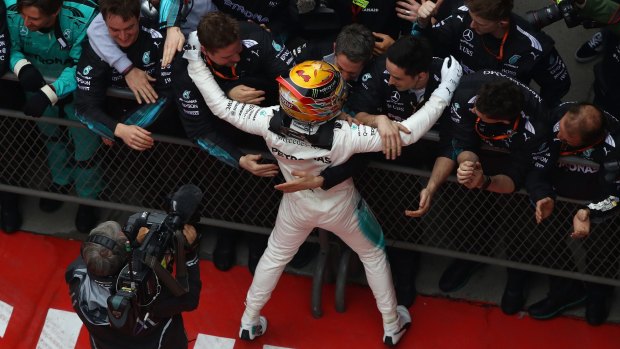 Meet and greet: Race winner Lewis Hamilton celebrates his win in Shanghai.