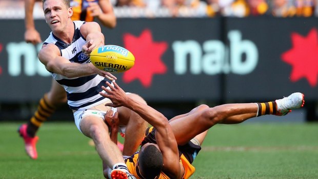Up and under:  Hawthorn's Josh Gibson tackles Joel Selwood in the 2015 round one clash.