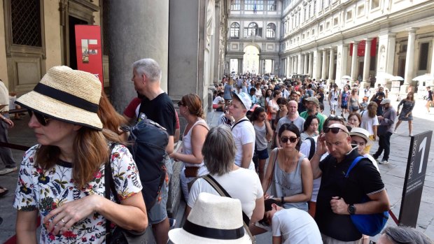 Tourists queue to enter the Uffizi during summer last year.