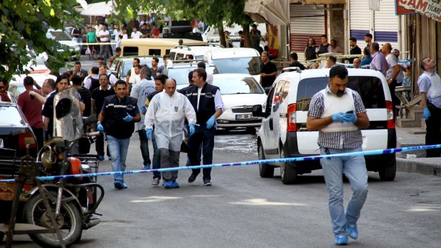 Police forensic experts examine the street following an attack on police officers in Diyarbakir, Turkey, on Thursday.