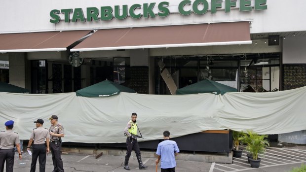 Police outside the Starbucks cafe damaged in the Jakarta attacks. 