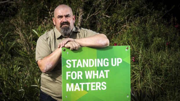Greens candidate Scott Jordan says campaign material outside his home was torn down and his daughter threatened.