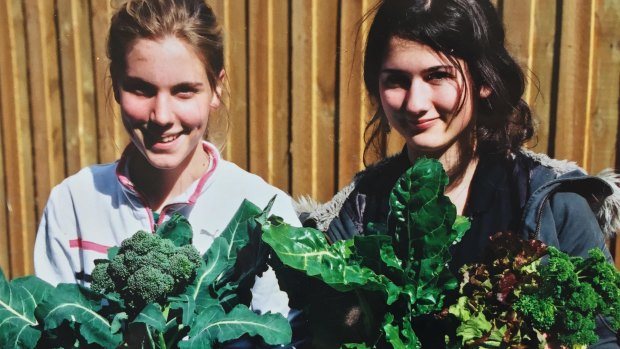 Henrietta Cook (right) with Lucy proudly shows off produce from the community garden.