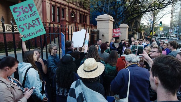 Students and parents protest outside at NSW Parliament.