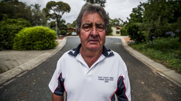 Resident Mick Farrelley stands in the quiet Kambah cul-de-sac where four of the nine houses contain Mr Fluffy asbestos.