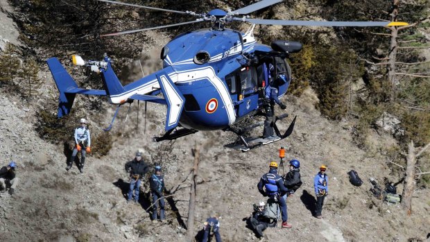 French gendarmes and investigators work amongst the debris at the site of the crash, near Seyne-les-Alpes.