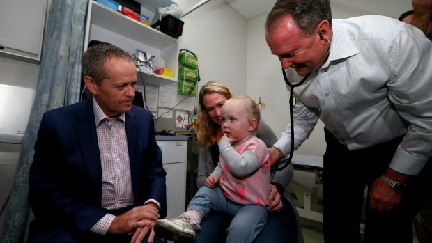 Opposition Leader Bill Shorten meets with Katherine Loupis and her 15-month-old daughter Eleanor, during a visit to the Drummoyne Medical Centre in Drummoyne, NSW on Sunday.
