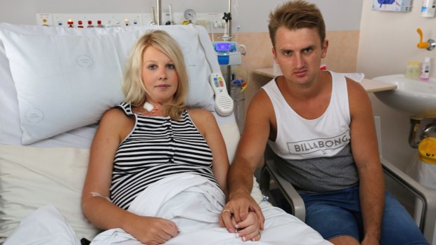 Parents Kane and Ashley Buchanan pictured after Ashley's emergency caesarean after contracting food poisoning from a Sylvania bakery.
