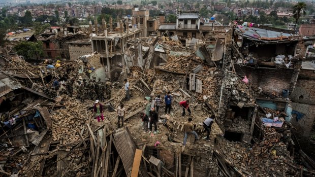 Residents foraging through their destroyed homes in Bhaktapur, Nepal, in the aftermath of last year's earthquake.