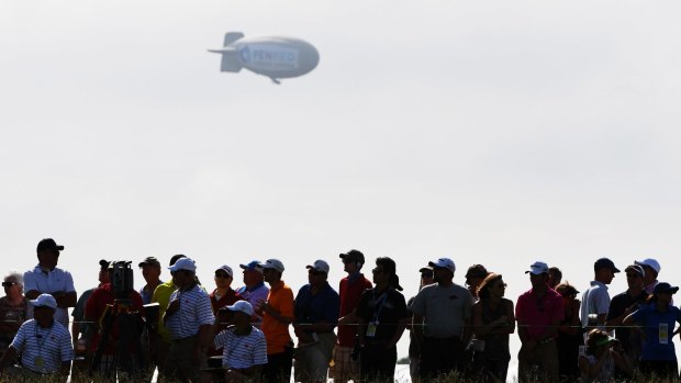 The blimp floats over the crowd earlier in the day.