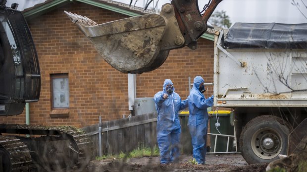 Workers demolish a Mr Fluffy home in Woden Valley, ACT, in 2014.