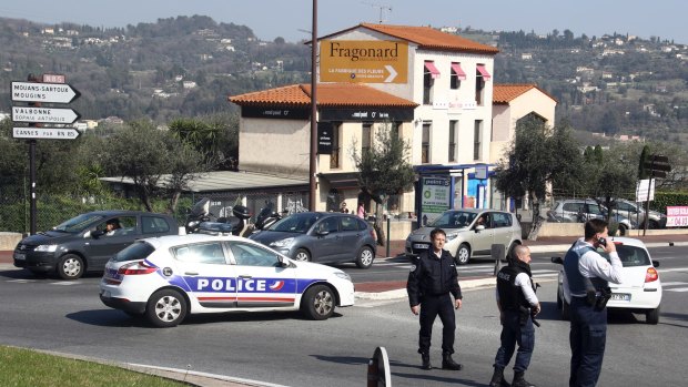 Police officers take position after an attack in a high school student in Grasse, southern France.