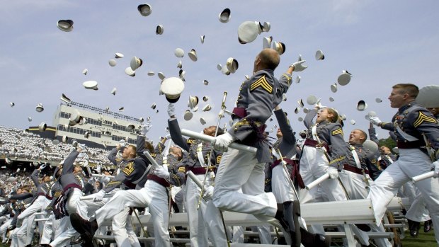 Hats off: Graduates toss their hats in the air after taking the oath of office and graduating from the US Military Academy.