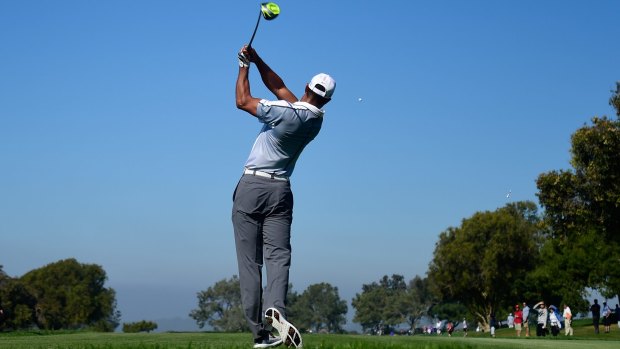 That famous stance: Tiger Woods plays his tee shot on the 15th hole of the north course at Torrey Pines.