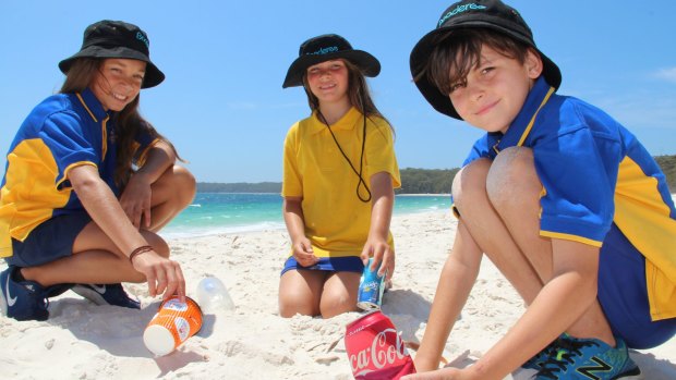Jervis Bay Primary School students Priscilla Dann, 11, Ocean Wellington, 8, and Elih Ardler-Pascoe, 10, helping clean up the beach to Keep Booderee Beautiful.