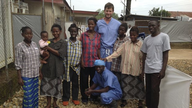 Ian Crozier and a nurse with Ebola survivors at Kenema Government Hospital.